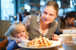 Beautiful woman with baby in cafe