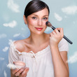 Portrait of a Beautiful woman applying makeup with brush on her Portrait of a Beautiful woman applying makeup with brush on her