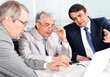 Portrait of three businessmen at the computer.