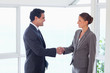 Photo: Side view of trades partner shaking hands Side view of trades partner shaking hands