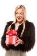 Foto: Surprised young woman with a present Surprised young woman with a present