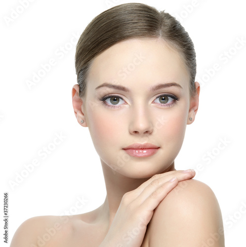 Photo: Face of beautiful girl with clean skin - isolated on white Face of beautiful girl with clean skin - isolated on white