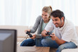 Foto: Cheerful couple playing video games Cheerful couple playing video games