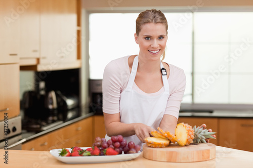 Photo: Woman posing with a sliced pineapple Woman posing with a sliced pineapple