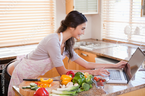 Photo: Woman looking for a recipe on the internet Woman looking for a recipe on the internet
