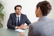 Handsome manager interviewing a female applicant