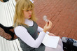 The schoolgirl sitting on a bench and watching the light bulb