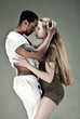 Young couple dances Caribbean Salsa, studio shot