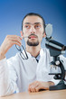 Chemist working with microscope