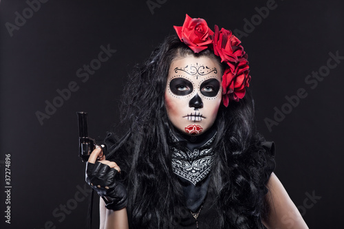 Photo: Serious woman in day of the dead mask portrait Serious woman in day of the dead mask portrait