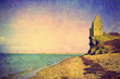 vintage photo of ancient tower ruins on the sea shore