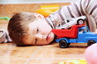 Little Boy Playing with Toy Car Close
