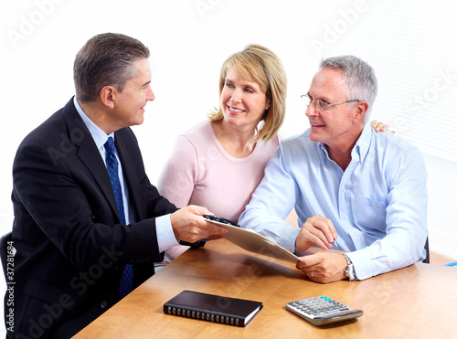 Photo: Senior couple with financial adviser. Senior couple with financial adviser.