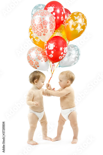 Photo: Small children present colorful balloons over white background Small children present colorful balloons over white background
