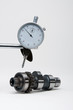 Engineers dial gauge above a camshaft.