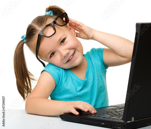 Photo: Little girl with laptop Little girl with laptop