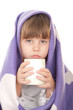 Beautiful little girl with a purple blanket and a cup of tea