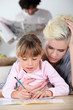 Baby-sitter and little girl doing homework