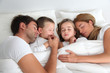 Family portrait laying in bed