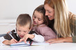 Woman helping kids with homework