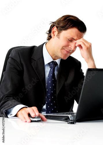 Photo: Hardworking businessman with headache Hardworking businessman with headache
