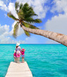 Daughters and mother in jetty on tropical beach