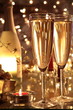 Closeup of champagne in glasses and bottle .
