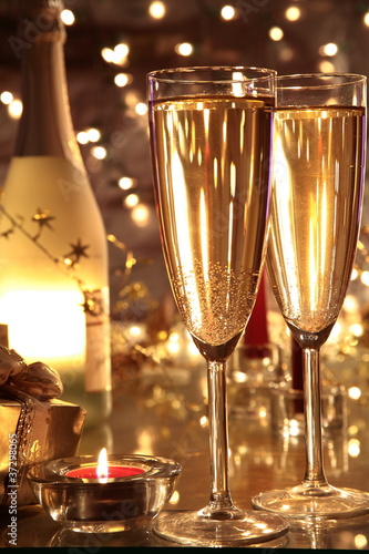 Photo: Closeup of champagne in glasses and bottle . Closeup of champagne in glasses and bottle .