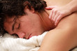 Foto: Young man relaxing during a shoulder massage Young man relaxing during a shoulder massage