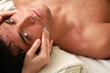 Foto: Young man relaxing during a massage with eyes open Young man relaxing during a massage with eyes open