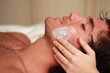 Foto: Facial massage to a relaxed young man at the spa Facial massage to a relaxed young man at the spa