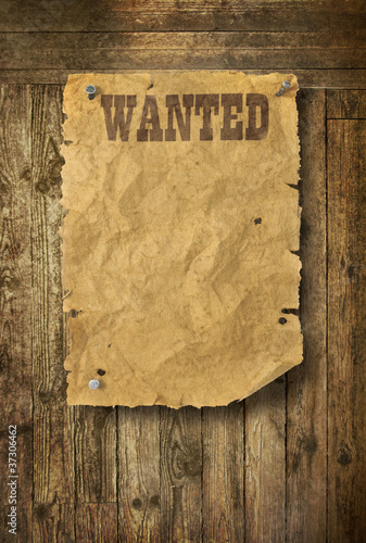 Photo: Wild West wanted poster on old wooden wall Wild West wanted poster on old wooden wall
