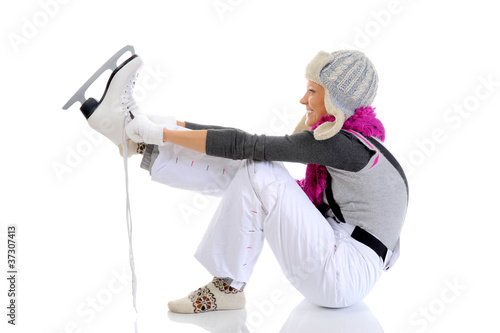 Photo: Beautiful girl puts on skates Beautiful girl puts on skates