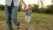 father and little boy running with toy car (slow-motion)