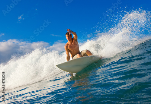 Photo: Surfer on Carves Blue Wave Surfer on Carves Blue Wave