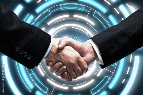 Photo: Handshake on background a touch screen interface Handshake on background a touch screen interface