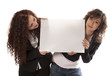 Young women holding billboard