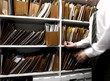 Business man files on shelf