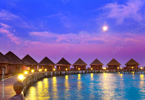 Photo: small houses on water on a sunset.. small houses on water on a sunset..