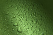 Drops on green wavy background making texture