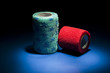 Different colour medical bandages on studio floor