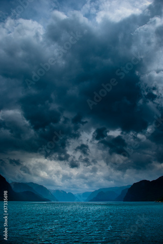Photo: Fjord with dark clouds Fjord with dark clouds