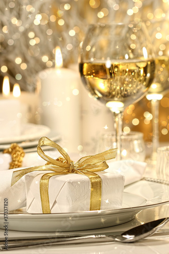 Photo: Gold ribbon gift with gold background Gold ribbon gift with gold background
