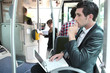 Photo: Commuter on a bus with a laptop Commuter on a bus with a laptop