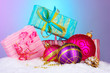 beautiful Christmas balls and gifts on snow on bright background beautiful Christmas balls and gifts on snow on bright background