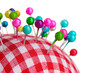Colored pinheads in pin-cushion isolated on white
