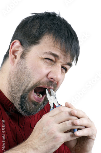 Photo: Man pulling his own tooth Man pulling his own tooth