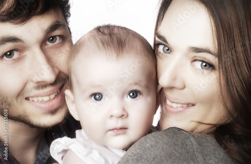 Photo: Young couple hugging their baby girl Young couple hugging their baby girl