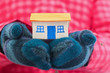 House holds woman in winter gloves