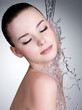 Water falling on the beautiful face of woman